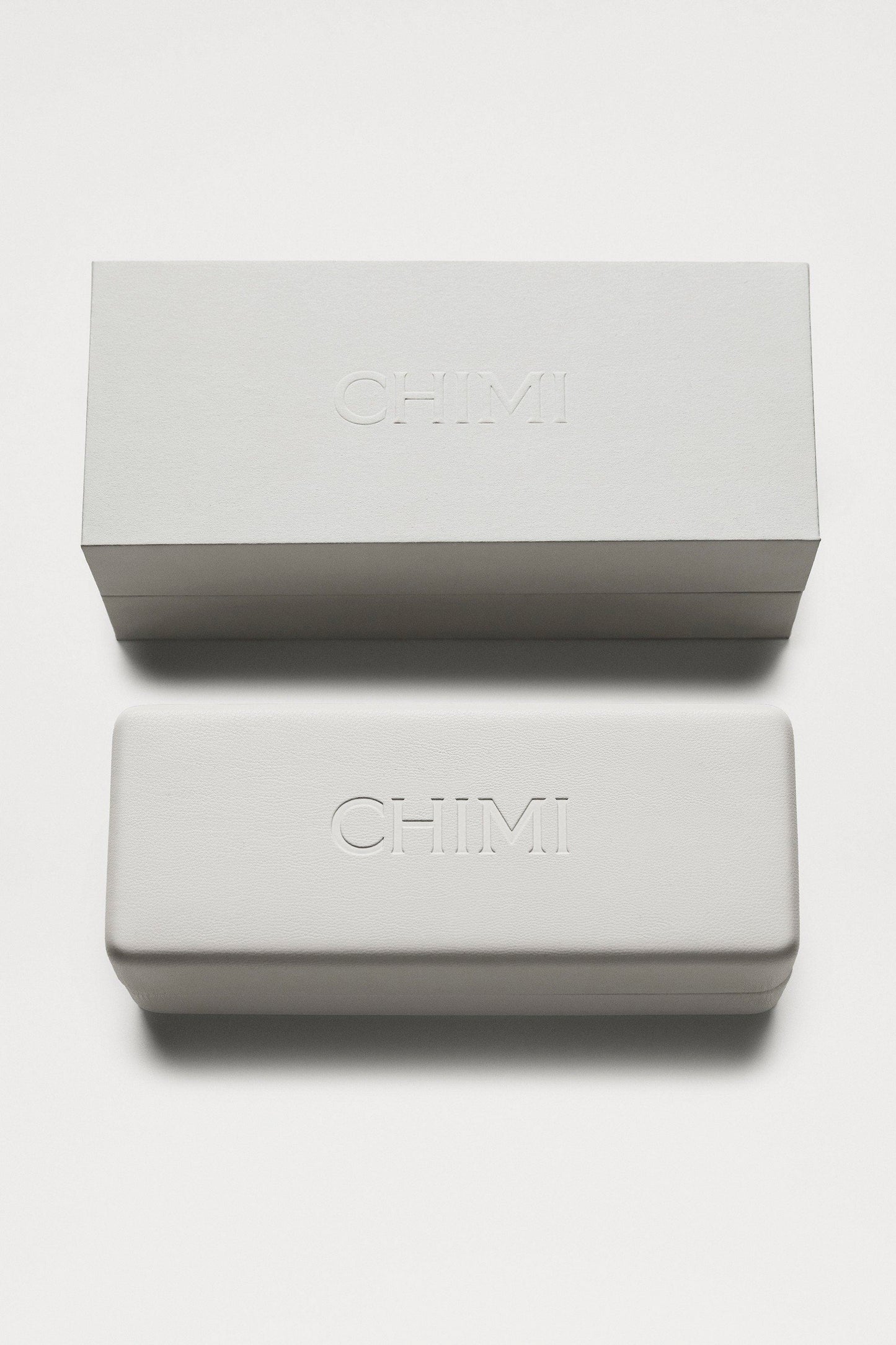 A white sunglasses box from Chimi and its White packaging.
