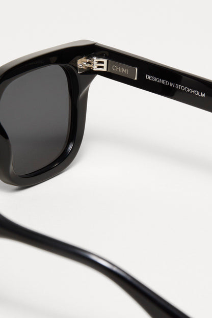 Closeup of the Black Chimi 04 sunglasses. Showing the enravings on the inside of the black square frame. 